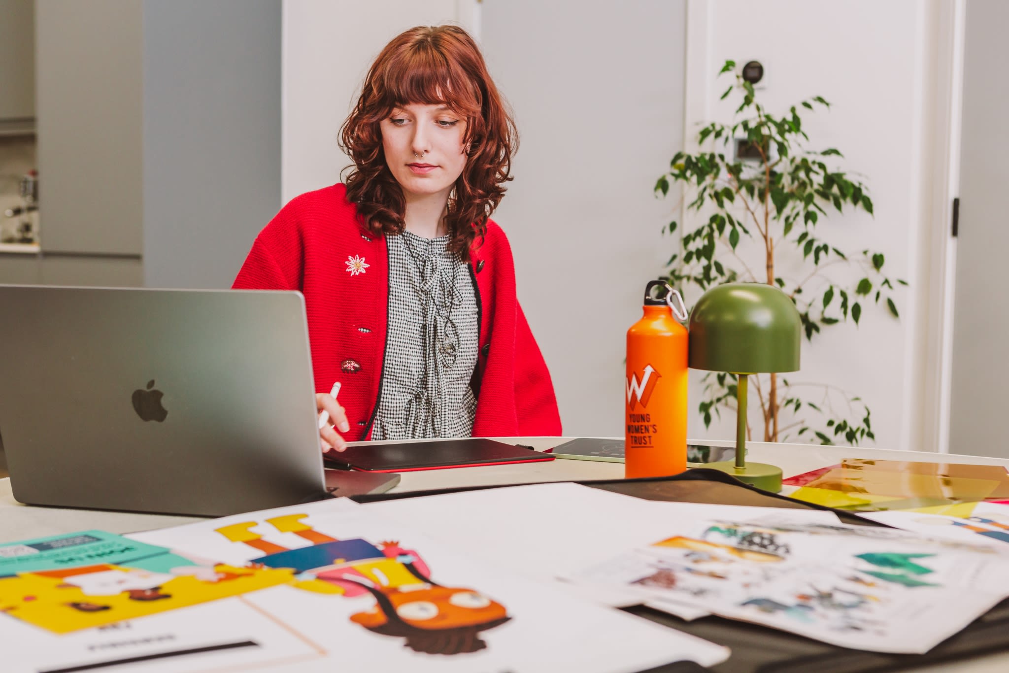 A young woman at work, staring into a laptop